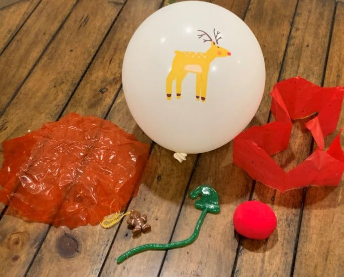 Holiday Balloon, clown nose, paper hat, toy parachute and sticky toy